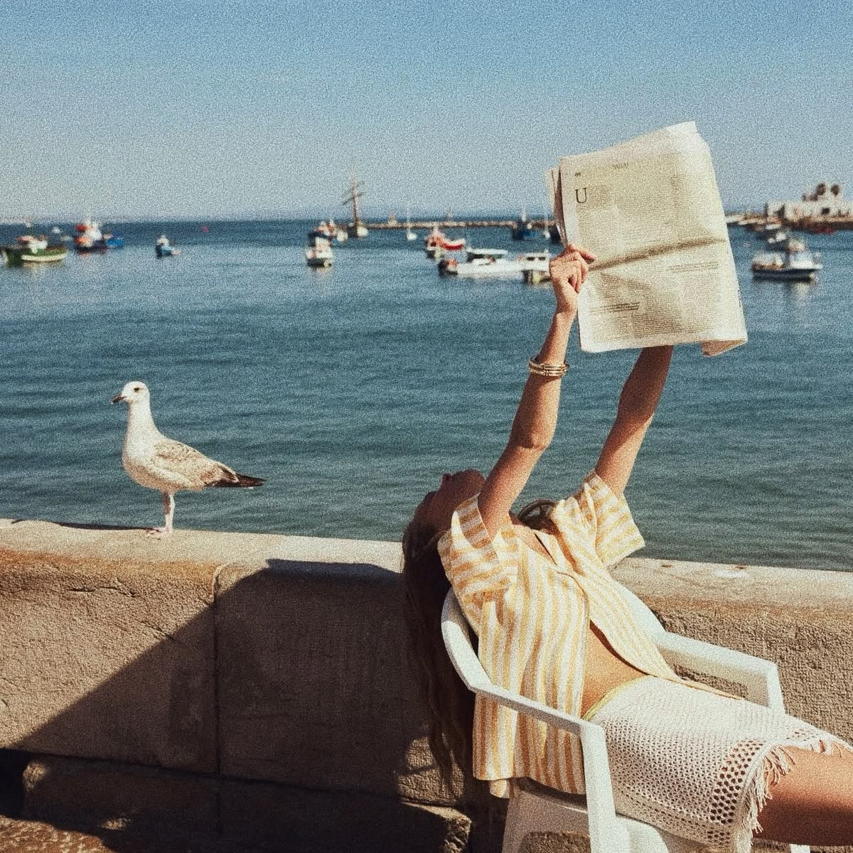 Reading by the harbour in the afternoon sun